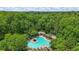 Community pool surrounded by lush greenery and plenty of lounge chairs for relaxing at 1444 Merrifield Ln, Marietta, GA 30062