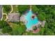 An aerial view of the community pool with ample seating surrounded by lush greenery and mature trees at 1444 Merrifield Ln, Marietta, GA 30062