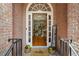 Warm entryway with hardwood floors, a welcoming mat, and decorative plants at 1444 Merrifield Ln, Marietta, GA 30062