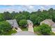 A charming two-story home with a brick facade, surrounded by lush greenery and mature trees at 1444 Merrifield Ln, Marietta, GA 30062