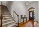 Elegant foyer with hardwood floors, a staircase, and an arched doorway at 1444 Merrifield Ln, Marietta, GA 30062