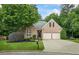 Charming brick home featuring a well-manicured lawn, two-car garage, and mature trees at 1444 Merrifield Ln, Marietta, GA 30062