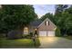 Charming single-story brick home with a landscaped yard, two-car garage and mature trees at 1444 Merrifield Ln, Marietta, GA 30062