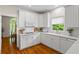 This kitchen features white cabinets, stone countertops, stainless appliances and a breakfast nook at 1444 Merrifield Ln, Marietta, GA 30062
