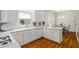 This kitchen features white cabinets, stone countertops, and a breakfast nook at 1444 Merrifield Ln, Marietta, GA 30062