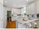 This kitchen features white cabinets, stone countertops, a breakfast bar, and stainless appliances at 1444 Merrifield Ln, Marietta, GA 30062