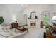 Inviting living room with a cozy fireplace, ample seating, and soft carpeting at 1444 Merrifield Ln, Marietta, GA 30062