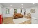 Open living room with wood floors, a couch, a chair, and two windows for natural light at 1444 Merrifield Ln, Marietta, GA 30062