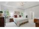 This main bedroom has tray ceilings, large windows, and carpeted floors at 1444 Merrifield Ln, Marietta, GA 30062