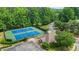 Community amenities with well-maintained tennis courts and nearby clubhouse surrounded by mature trees at 1444 Merrifield Ln, Marietta, GA 30062
