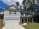 Charming two-story home with a two-car garage, landscaped yard, and inviting front porch at 1825 Harmony Trce, Lithonia, GA 30058