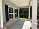 Covered front porch with brick accents and white columns, perfect for relaxing at 1825 Harmony Trce, Lithonia, GA 30058