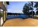 A wood deck overlooking the lake, with clear railings showcasing serene waterfront views at 2746 Emerald Dr, Jonesboro, GA 30236