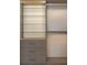 Close-up of custom closet with shelves, drawers, and lighting at 2746 Emerald Dr, Jonesboro, GA 30236