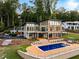 A modern lake house featuring a backyard pool with patio and lush landscaping at 2746 Emerald Dr, Jonesboro, GA 30236