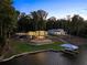 Stunning waterfront home with expansive windows, terraced landscaping, and private dock, offering luxurious lakeside living at 2746 Emerald Dr, Jonesboro, GA 30236