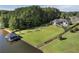 Lakeside estate featuring a modern home with a sprawling lawn and a covered boat dock at 3085 Lake Park Dr, Jonesboro, GA 30236