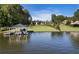 Waterfront property with a modern home on a manicured lawn and a covered boat dock at 3085 Lake Park Dr, Jonesboro, GA 30236