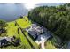 Aerial view of a luxury home with a pool, private dock, and expansive lawn on a lakefront property at 3085 Lake Park Dr, Jonesboro, GA 30236