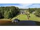 Waterfront property with sprawling lawn, luxurious home, and private dock, all surrounded by verdant trees at 3085 Lake Park Dr, Jonesboro, GA 30236