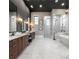 Luxurious bathroom featuring double vanities, marble floors, and a separate shower and soaking tub at 3085 Lake Park Dr, Jonesboro, GA 30236