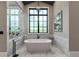 Contemporary bathroom with standalone tub, walk-in shower, and statement lighting at 3085 Lake Park Dr, Jonesboro, GA 30236