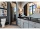 Modern bathroom featuring a vanity, round mirror, and glass-enclosed shower with beautiful tile and fixtures at 3085 Lake Park Dr, Jonesboro, GA 30236