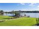 Well-maintained boat dock with boat lift, surrounded by a green lawn and serene lake waters at 3085 Lake Park Dr, Jonesboro, GA 30236