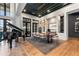 Stunning dining room with an oversized wood table, designer lighting, and walls of windows at 3085 Lake Park Dr, Jonesboro, GA 30236
