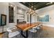 Dining room with a live edge dining table, unique lighting, and decorative built-ins at 3085 Lake Park Dr, Jonesboro, GA 30236