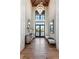 Grand foyer with soaring ceilings, hardwood floors, chandelier, and elegant furnishings at 3085 Lake Park Dr, Jonesboro, GA 30236