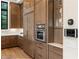 Kitchen featuring custom wood cabinetry, built-in stainless steel appliances, and smart home technology at 3085 Lake Park Dr, Jonesboro, GA 30236