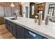 Close up shot of kitchen island featuring modern design, white marble countertops, and blue cabinetry at 3085 Lake Park Dr, Jonesboro, GA 30236