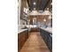 Gourmet kitchen featuring a chevron backsplash, pot filler, wooden beams, an island, and stainless steel appliances at 3085 Lake Park Dr, Jonesboro, GA 30236