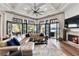 Elegant living room with doors to outdoor patio and lake views, with a fireplace at 3085 Lake Park Dr, Jonesboro, GA 30236