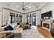 Bright living room with fireplace, large windows, comfortable seating and stylish decor at 3085 Lake Park Dr, Jonesboro, GA 30236