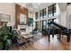 Living room showcasing a piano, fireplace, high ceilings, and oversized windows at 3085 Lake Park Dr, Jonesboro, GA 30236