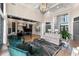 Bright living room with tall ceilings, modern chandelier, comfortable seating, and hardwood floors at 3085 Lake Park Dr, Jonesboro, GA 30236