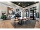 Expansive living and dining space with fireplace, piano, large dining table and lake views at 3085 Lake Park Dr, Jonesboro, GA 30236