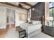 Beautiful main bedroom with wood beam ceilings, panelled wall, and ample natural light at 3085 Lake Park Dr, Jonesboro, GA 30236