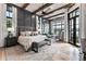 Spacious main bedroom with wood beams, large windows and a comfortable seating area at 3085 Lake Park Dr, Jonesboro, GA 30236