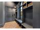 Functional mudroom with built-in benches, storage cubbies, and a herringbone-patterned floor at 3085 Lake Park Dr, Jonesboro, GA 30236