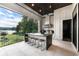 The covered patio has a functional outdoor kitchen with lake views and seating at the bar at 3085 Lake Park Dr, Jonesboro, GA 30236