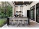 The outdoor kitchen on the covered patio includes a grill, sink, and bar seating at 3085 Lake Park Dr, Jonesboro, GA 30236