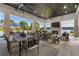 Covered outdoor living space with a fireplace, ceiling fans, water view, and comfortable seating at 3085 Lake Park Dr, Jonesboro, GA 30236