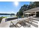 Gorgeous infinity pool with lounge chairs provides a stunning view of the lake and surrounding landscape at 3085 Lake Park Dr, Jonesboro, GA 30236