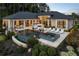 A beautiful backyard featuring a pool, hot tub, fire pit, and lounge area, perfect for outdoor entertaining at 3085 Lake Park Dr, Jonesboro, GA 30236