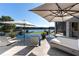 Tranquil infinity pool with seating and umbrellas, creating a luxurious lakeside retreat at 3085 Lake Park Dr, Jonesboro, GA 30236