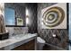 Stylish powder room with unique wallpaper, a vessel sink, elegant lighting, and modern fixtures at 3085 Lake Park Dr, Jonesboro, GA 30236