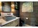 The powder room features wood paneled walls, a unique mirror, and stylish fixtures at 3085 Lake Park Dr, Jonesboro, GA 30236